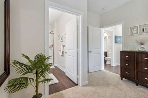 A white door is open to a bathroom.at Century Hampton Roads, Suffolk, VA  