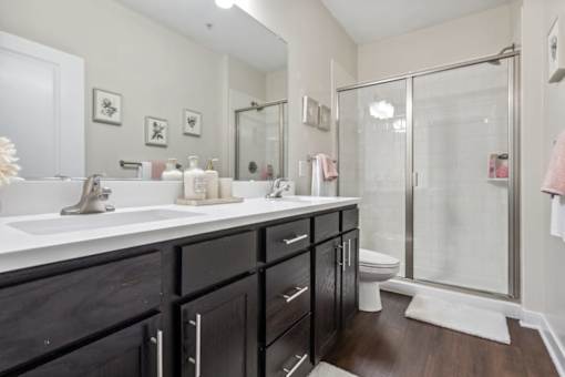 A bathroom with a white sink and black cabinets.at Century Hampton Roads, Suffolk, VA 23435  