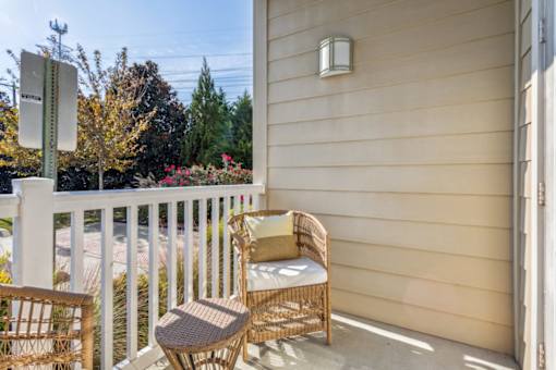 A patio with a chair and a table.at Century Hampton Roads, Suffolk, 23435  