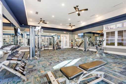 A gym with a variety of equipment including treadmills, weights, and exercise machines.at Century Hampton Roads, Virginia  