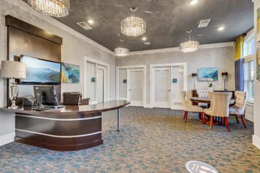 A reception area with a desk and chairs.at Century Hampton Roads, Suffolk  
