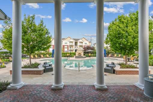 A view of a pool through a white column.at Century Hampton Roads, Suffolk Virginia  