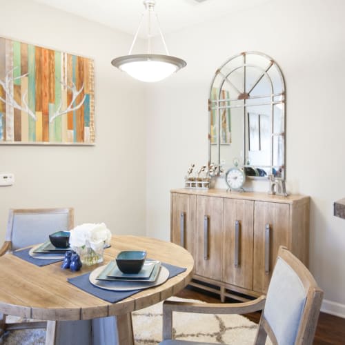 A dining room with a wooden table and chairs.
