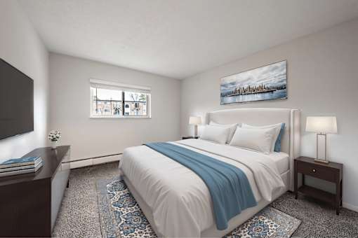 A bedroom with a large bed and a painting on the wall.