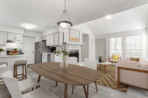 A modern kitchen with a dining table and chairs.