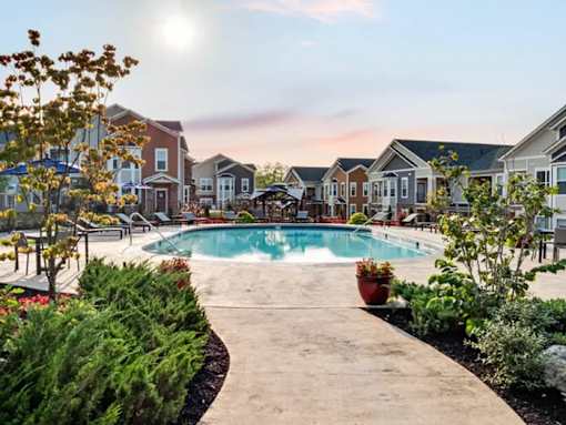 A sunny day at a residential area with a swimming pool and a walkway.