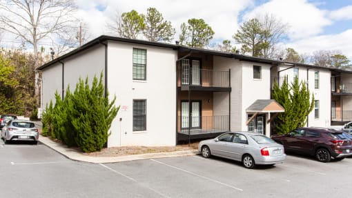 Exterior photo of parking lot and apartments at Parkside Sandy Springs Atlanta, GA
