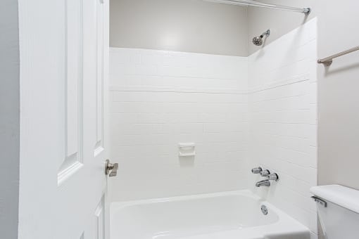 Spacious tub and shower with tiled walls at Parkside at Sandy Springs Atlanta, GA