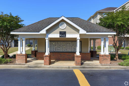 a small building with a sign on it on the side of a street
