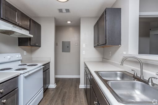 the preserve at ballantyne commons apartment kitchen with white appliances and dark cabinets