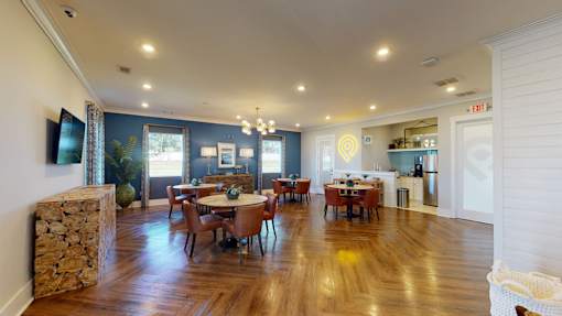 A dining room with a wooden table and chairs.