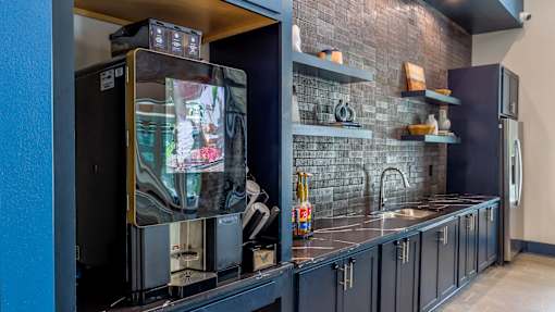A modern kitchen with a refrigerator and a sink.