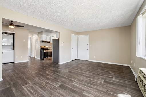 A room with a wood floor and a ceiling fan.
