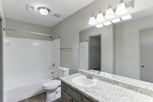A white toilet sits next to a sink in a bathroom.