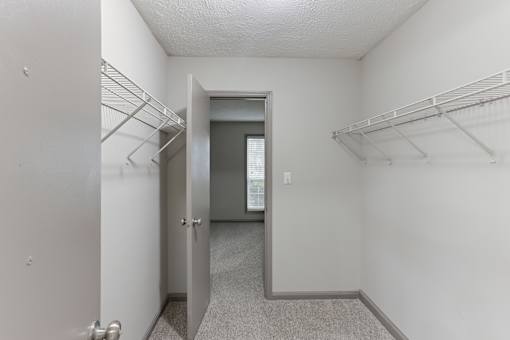 A hallway with a door on the left and a door on the right.
