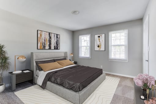 a bedroom with grey walls and a gray bed  at The Mason Mills Apartments, Georgia, 30033