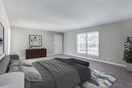 a bedroom with grey walls and carpet  at The Mason Mills Apartments, Decatur, GA