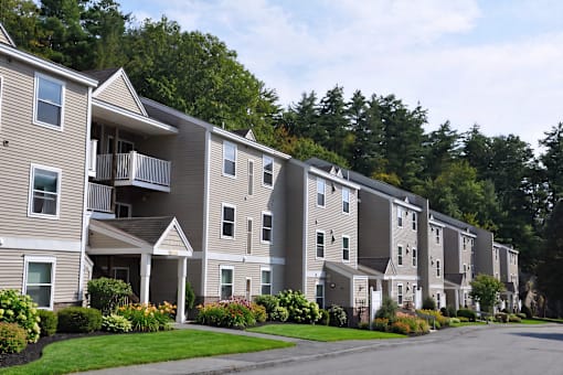 Apartment complex with a green lawn in front.