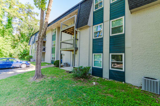 a building with green shutters and a blue car parked in front of it at Summit East Ridge, East Ridge