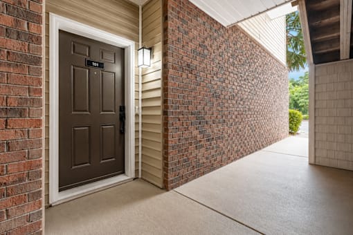 A brown door with a glass window is on the left side of the image.