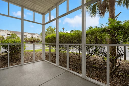 A sunny day in a patio with a view of the street.