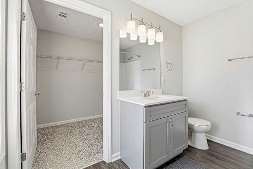 A bathroom with a white sink and a toilet.