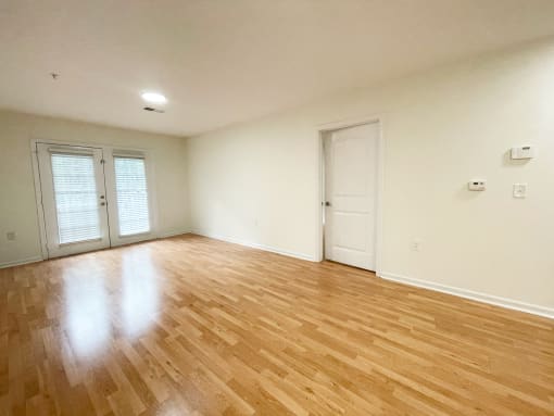 Living room with beautiful hardwood floors at Oasis at Twinwood in Wilmington, NC