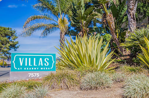 a sign that reads villas at kennedy mesa in front of plants