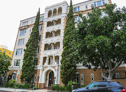 A tall building with a tree in front of it.