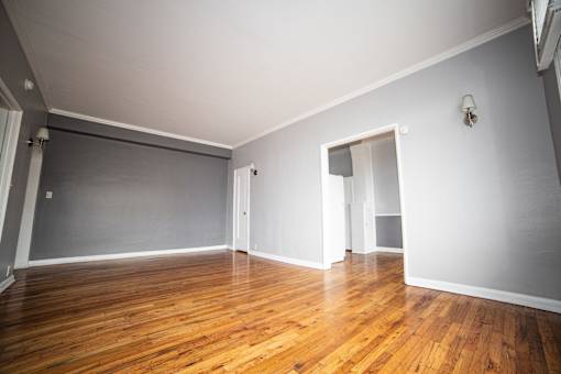 A room with wooden floors and white walls.