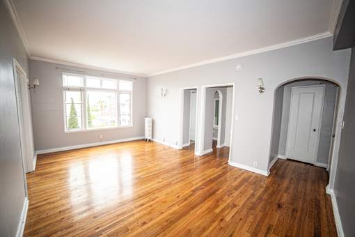 A room with wooden floors and white walls.