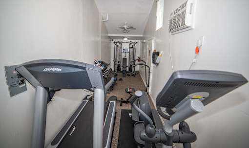 a room with a lot of exercise equipment