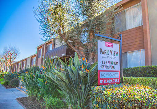 a group of apartments with a sign in front of them