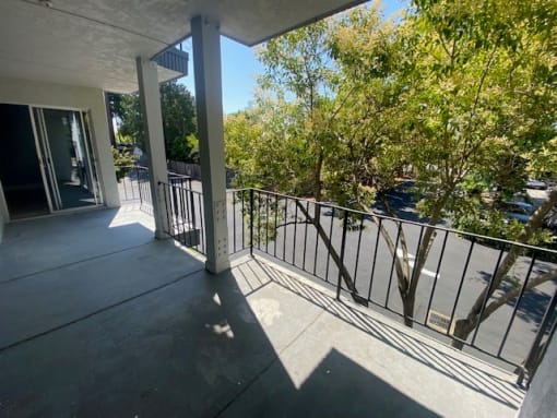 a large balcony with a view of a parking lot