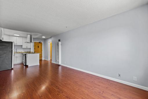 A room with wooden floors and white walls.