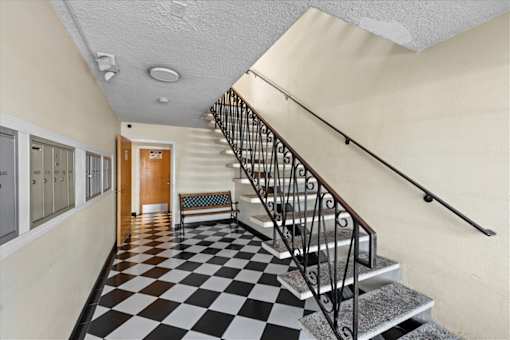 A hallway with a black and white checkered floor.