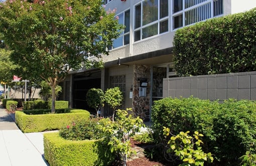 Front of 36th ave Apartments a building with large windows facing the street side