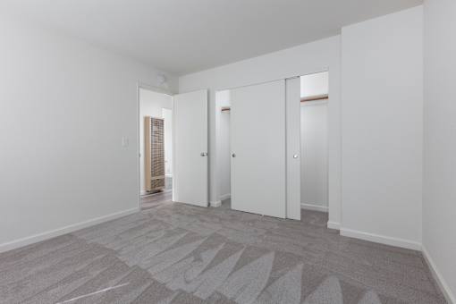 a living room with white walls and white doors