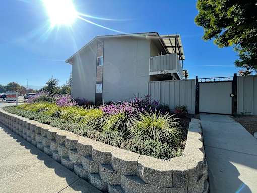 A house with a well-maintained garden in front.