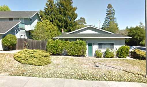 A house with a green door and a grey roof.