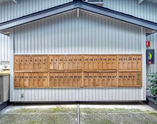 A series of numbered wooden boxes are mounted on a wall.