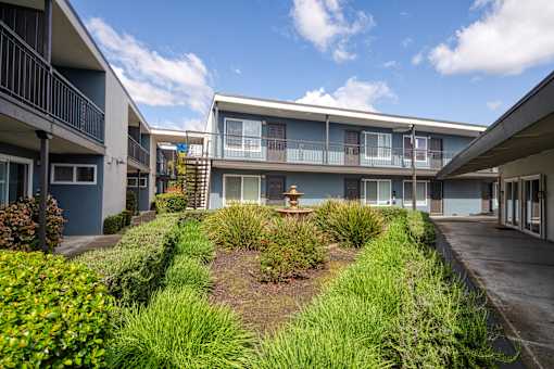 A sunny day at the apartment complex with a clear blue sky.