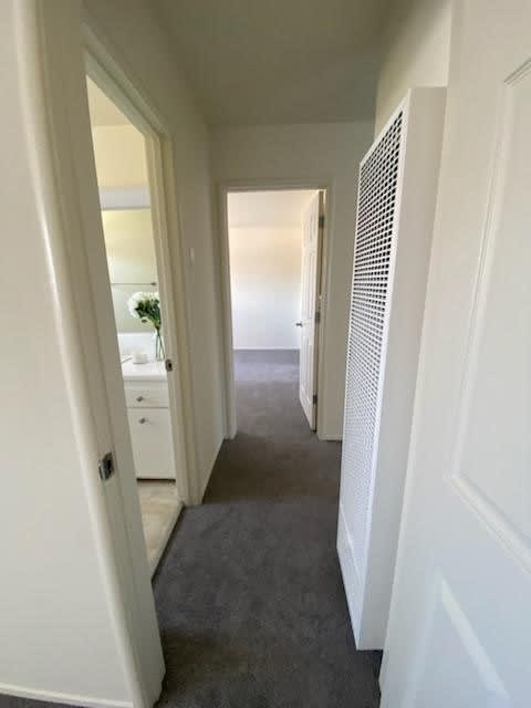 a row of mirrors in a room with a wood floor and mirrors on the wall