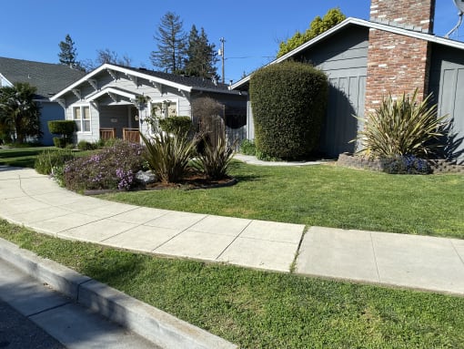 a house with a sidewalk in front of it