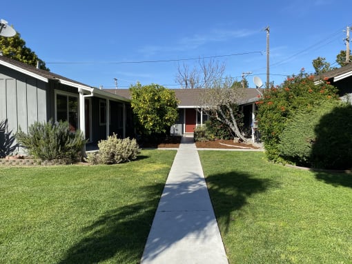 a sidewalk in front of a house