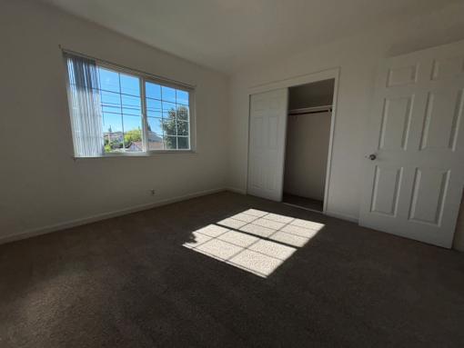 A room with a large window and a door.
