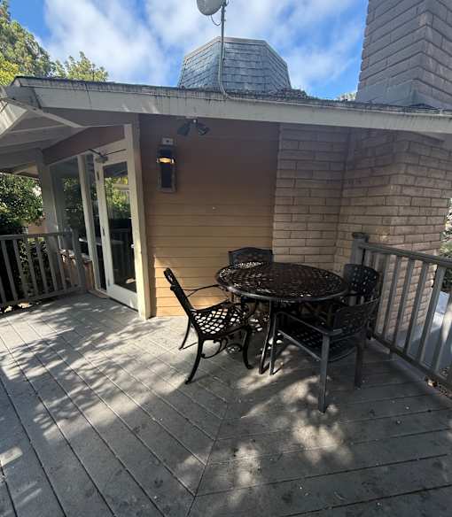 A patio with a table and chairs.