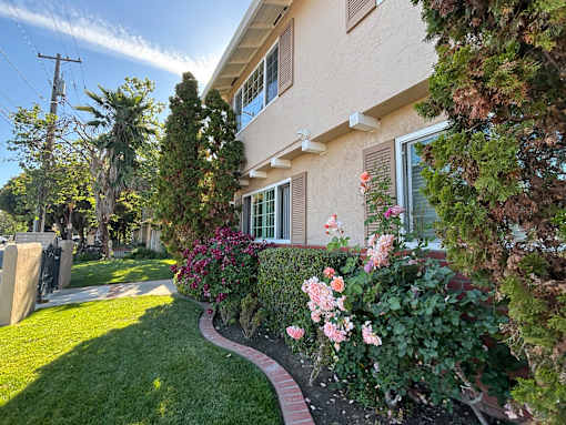 A house with a well-maintained garden in front.