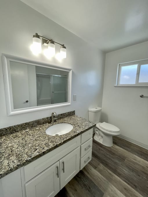 an empty bathroom with a sink and a toilet