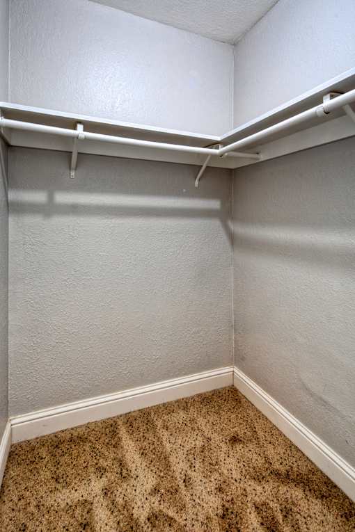 A small, empty room with a carpeted floor.